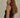 Regi Top side view of black sleeveless ribbed tank top with close fit silhouette.