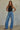 Regi Top black fitted sleeveless top paired with relaxed blue denim jeans.