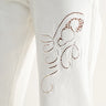 Relic Embroidered Denim Pants – close-up detail of cutwork embroidery on white denim.