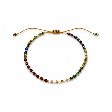 Renu Bracelet flat lay showing multicolor beads, delicate gold details, and sliding adjustable closure.
