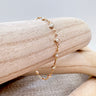 Gold Rhodes Bracelet with square pearl accents by Matte on wooden display