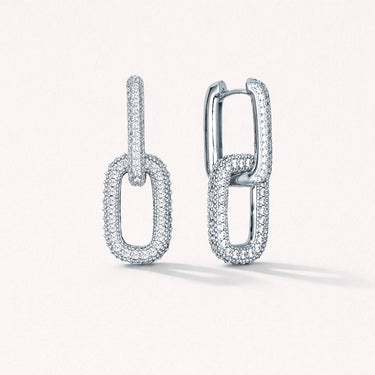 Risha Huggie Earrings in silver featuring elongated link design with pavé-set zirconia stones, shown on a neutral background, sleek everyday statement earrings