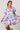 Model wearing light blue mini dress with puff sleeves and pink animal print
