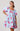 Model wearing light blue mini dress with puff sleeves and pink animal print