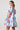 Model wearing light blue mini dress with puff sleeves and pink animal print