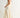 Roblen Pant cream wide-leg trousers side view showing fluid drape and airy lightweight fabric movement.