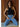Model wearing the black Romett Top with a ribbed knit texture, mock neckline, sleeveless cut, fitted cropped silhouette, and relaxed light-wash denim jeans.