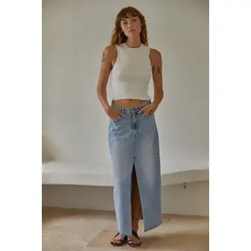 Woman styling the off white Romett Top with light-wash jean skirt, showcasing the fitted ribbed silhouette, cropped length, and minimalist everyday style.