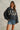 Lifestyle shot of Rope USA Knit Sweater in navy styled outdoors with sneakers and denim shorts.