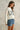 Side view of Rope USA Knit Sweater in off white showing red whipstitch sleeve detail.