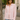 woman wearing Rosewood Ruffle Blouse in light pink, long sleeves, button-down with ruffle trim, styled with blue jeans on the street