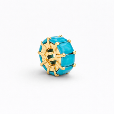 Sabi Charm turquoise zirconia charm variation with gold setting angled view highlighting vibrant color and dimensional sparkle