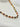 Sabrina Necklace by Matte, multicolor beaded gold plated necklace on white surface