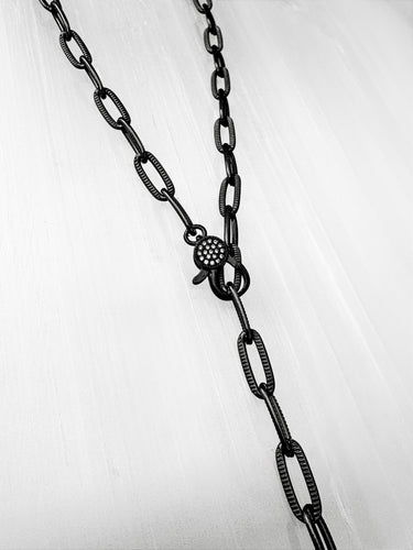 Seint black enamel chain necklace by Matte, 18 inch length with pavé clasp, displayed on light background