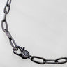 Seint necklace by Matte, black enamel chain with pavé clasp detail on light background