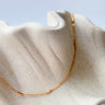Sequence gold filled chain necklace by Matte, minimalist bar detail chain on neutral fabric