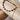 Bracelet with brown and gold beads on a wooden surface by Matte Jewelry
