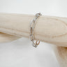 Silver link chain bracelet with rectangular oversized links displayed on wood stand - Matte Jewelry