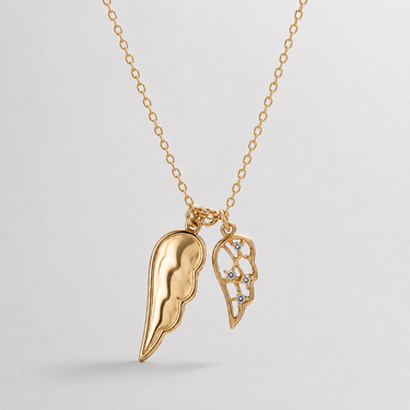 Sola Wings Necklace, double wing pendant shown with polished gold side and crystal detailing.