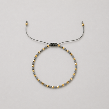 Solei Bracelet delicate grey and gold bead bracelet featuring adjustable pull-tie design