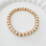 Stelle gold and pearl stretch bracelet displayed on white surface