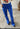 Close-up of Stones Pant showing mid waist and flared leg in electric blue.