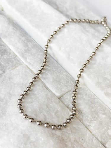 Sunbeam Necklace by Matte, silver beaded chain on white marble surface