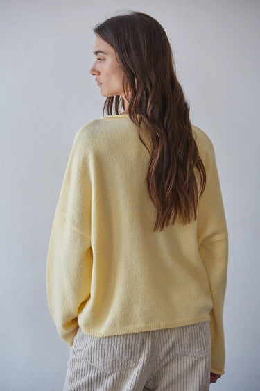 Back profile of the Syrat Sweater featuring the oversized silhouette, dropped shoulders, ribbed hem, and soft knit construction.