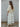 Talina lightweight ivory knit cardigan with a relaxed silhouette, soft knit texture, elbow-length sleeves, and rolled-edge trim, shown from the back.