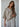 Talina lightweight oatmeal knit cardigan with a relaxed silhouette, elbow-length sleeves, button-front closure, and rolled-edge finish, shown from the front.