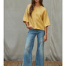 Talina lightweight mustard yellow knit cardigan featuring rolled-edge trim, elbow-length sleeves, and a relaxed fit, shown from the front.