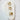 Terni ear cuff set in gold with star, lightning bolt, and butterfly designs displayed on white stone