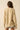Back view of relaxed beige knit sweater with oversized fit.