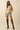 Full outfit with tiger embroidered sweater, denim shorts, and tall lace-up boots.