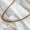 Tight Necklace by Matte, gold filled ball chain choker on white marble surface