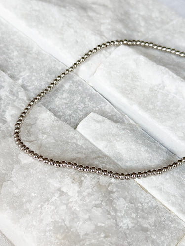 Tight Necklace by Matte, silver ball chain choker on white marble surface