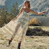 Tiks Layering Midi Dress ivory tiered lace dress captured mid-movement highlighting layered ruffle hem and lightweight flowing texture.