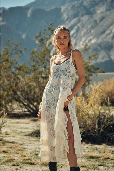 Tiks Layering Midi Dress ivory lace midi dress front view showing soft neckline, fluid drape, and airy lace fabric in natural sunlight.