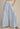 Blue and white vertical striped wide-leg pants shown from the front with a high-rise elastic waistband.