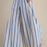 Side view of blue and white striped palazzo pants highlighting the relaxed wide-leg silhouette and flowing fabric.