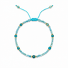 Tral Bracelet adjustable turquoise faceted beaded bracelet with gold-tone accents on neutral background.