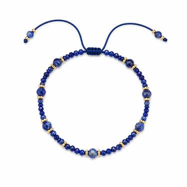 Tral Bracelet adjustable blue faceted beaded bracelet with gold-tone accents on neutral background.