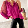 Model wearing Shibori Blouse in fuchsia silk with lace sleeves, tucked  — Matte Concept Store