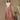 Model wearing metallic tangerine maxi skirt with white boho top.