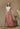 Model wearing metallic tangerine maxi skirt with white boho top.