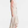 Side view of the Vania Dress showing its figure-skimming silhouette and cascading ruffle hem.