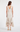 Back view of the Vania Dress showing the flowing midi length and layered ruffle detailing.