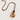 Vina Necklace by Matte featuring a long brown cord with a sculptural marbled amber and cream pendant, photographed on a textured neutral background.