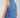 Woman wearing a blue denim crop top against a plain background