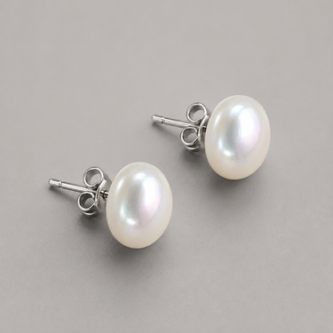 Wak Stud Earrings featuring freshwater button pearls with a smooth lustrous finish, sterling silver posts, and softly rounded silhouettes.